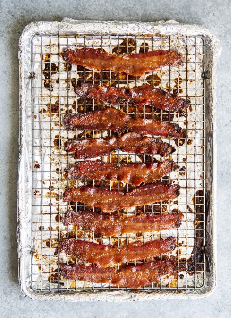 An overhead photo of a baking pan covered with strips of brown sugar bacon.