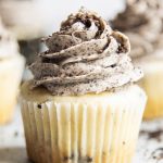 A vanilla cupcake topped with a cookies and cream frosting.