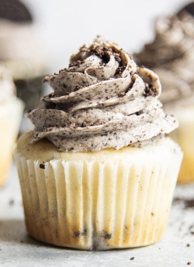 A vanilla cupcake topped with a cookies and cream frosting.