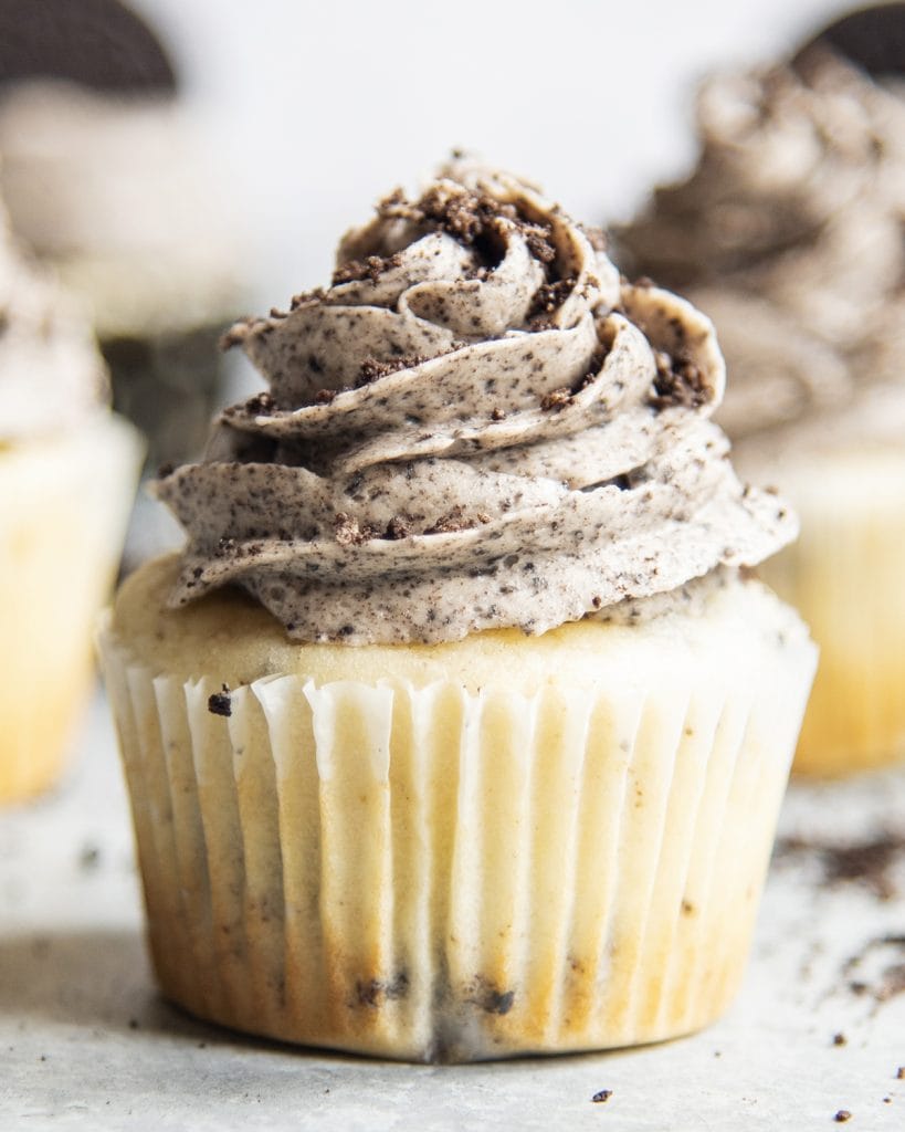 A vanilla cupcake topped with a cookies and cream frosting.