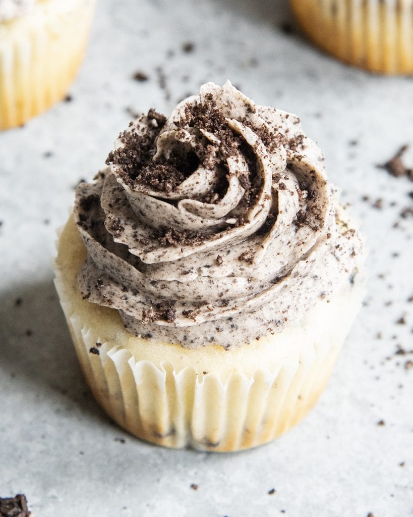 Oreo frosting piped with a 1M tip and topped with small Oreo crumbs.