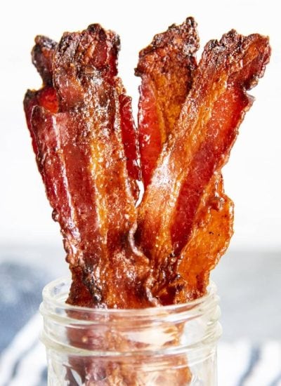 A close up of strips of brown sugar bacon in a jar.