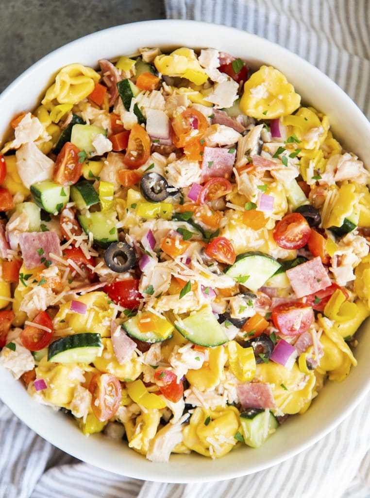 An overhead photo of a bowl of Italian pasta salad with tortellini.