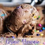 A scoop of cosmic brownie ice cream in an ice cream container with a text block over the bottom for pinterest.
