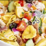 A close up of a bowl of tortellini pasta salad with text overlay for pinterest.