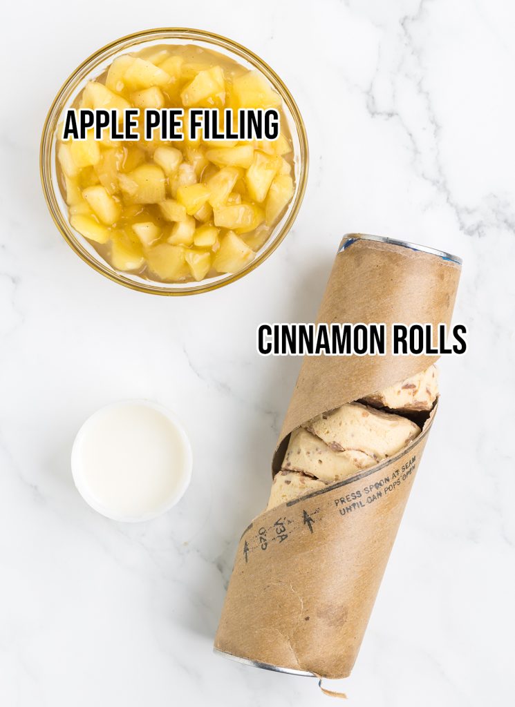 An overhead of the two ingredients needed to make cinnamon roll apple pie cups, showing canned cinnamon rolls and a bowl of apple pie filling.