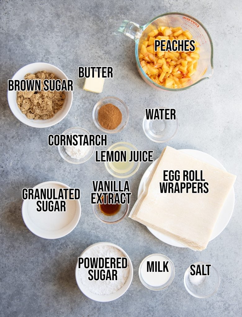 An overhead photo of the ingredients needed to make peach cobbler egg rolls.