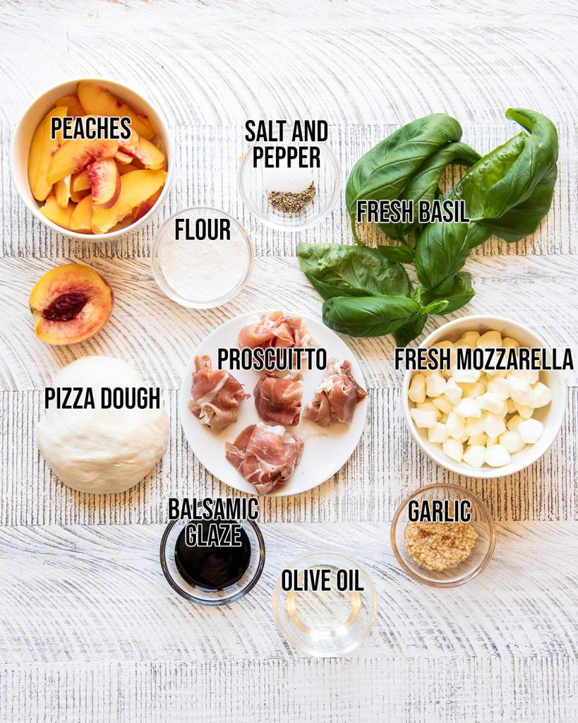 An overhead photo of the ingredients needed to make prosciutto and peach pizza.