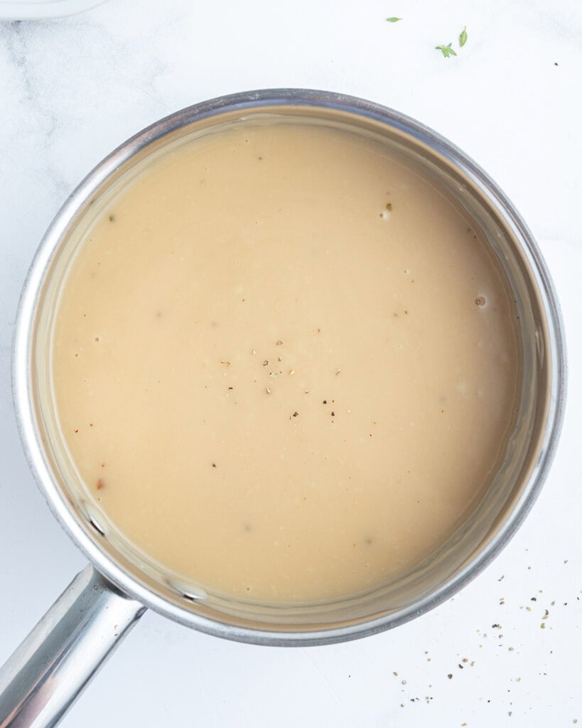 A pan of a light brown gravy.