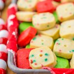 A tray of Christmas shortbread cookies, they are holiday colored, red, green, and white with sprinkles.