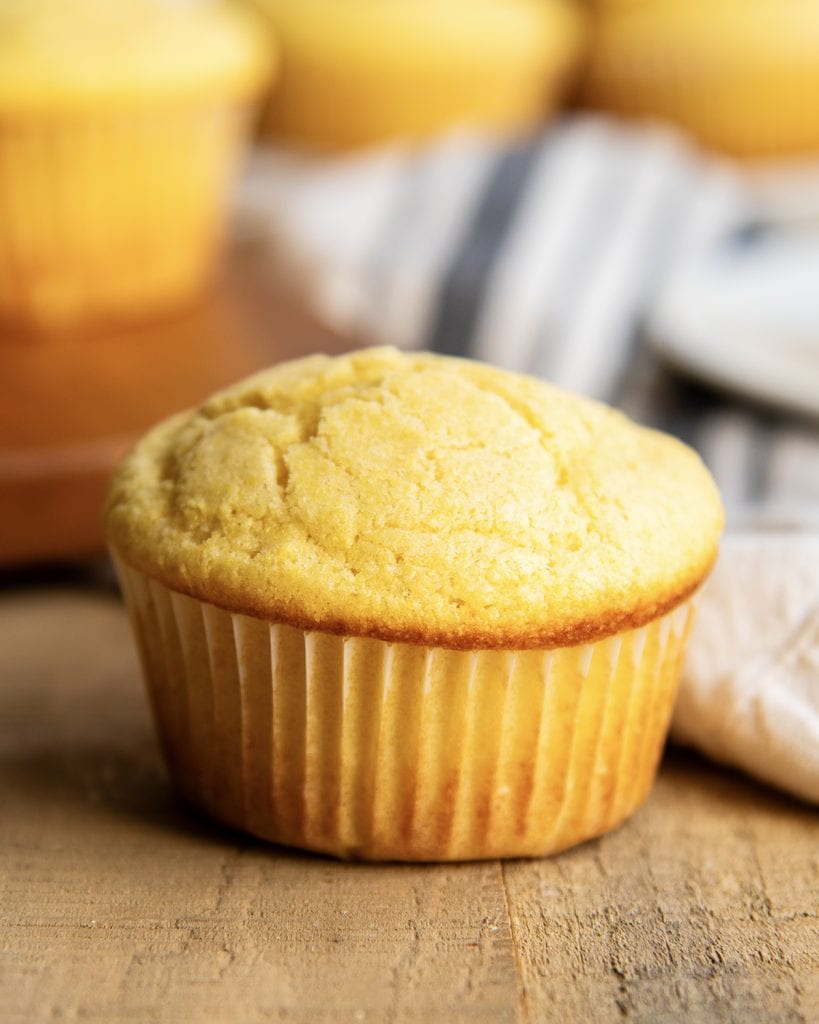 A cornbread muffin on a wooden table.