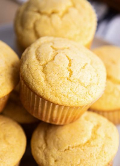 A pile of cornbread muffins on a plate.