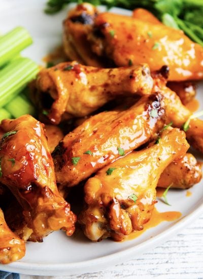 A close up of air fryer chicken wings coated in honey chipotle sauce.
