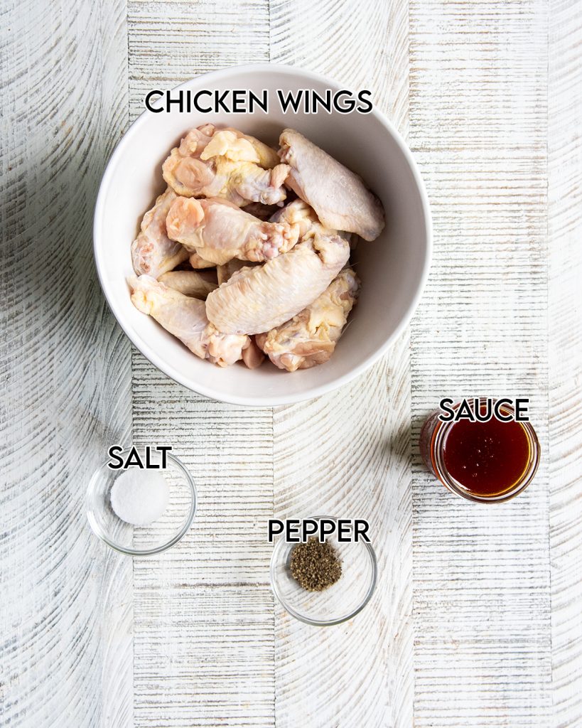 An overhead photo of the 4 ingredients needed to make chicken wings in the air fryer.