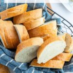 A photo of slices of french bread in a basket with a text block over the top for pinterest.