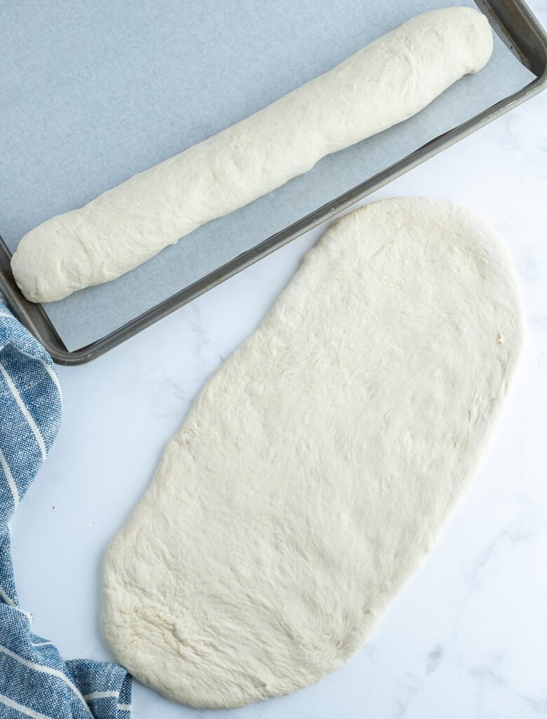 A french bread loaf flattened to show how to form the loaf.