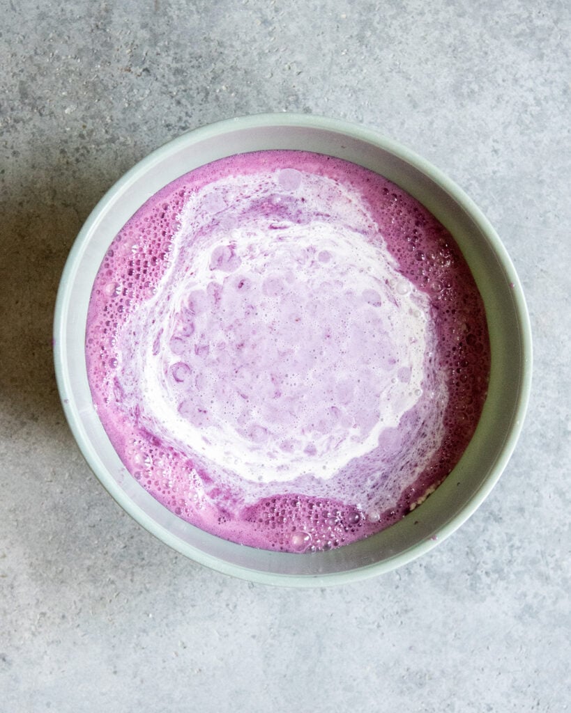A bowl of blueberry puree and heavy cream to make ice cream.