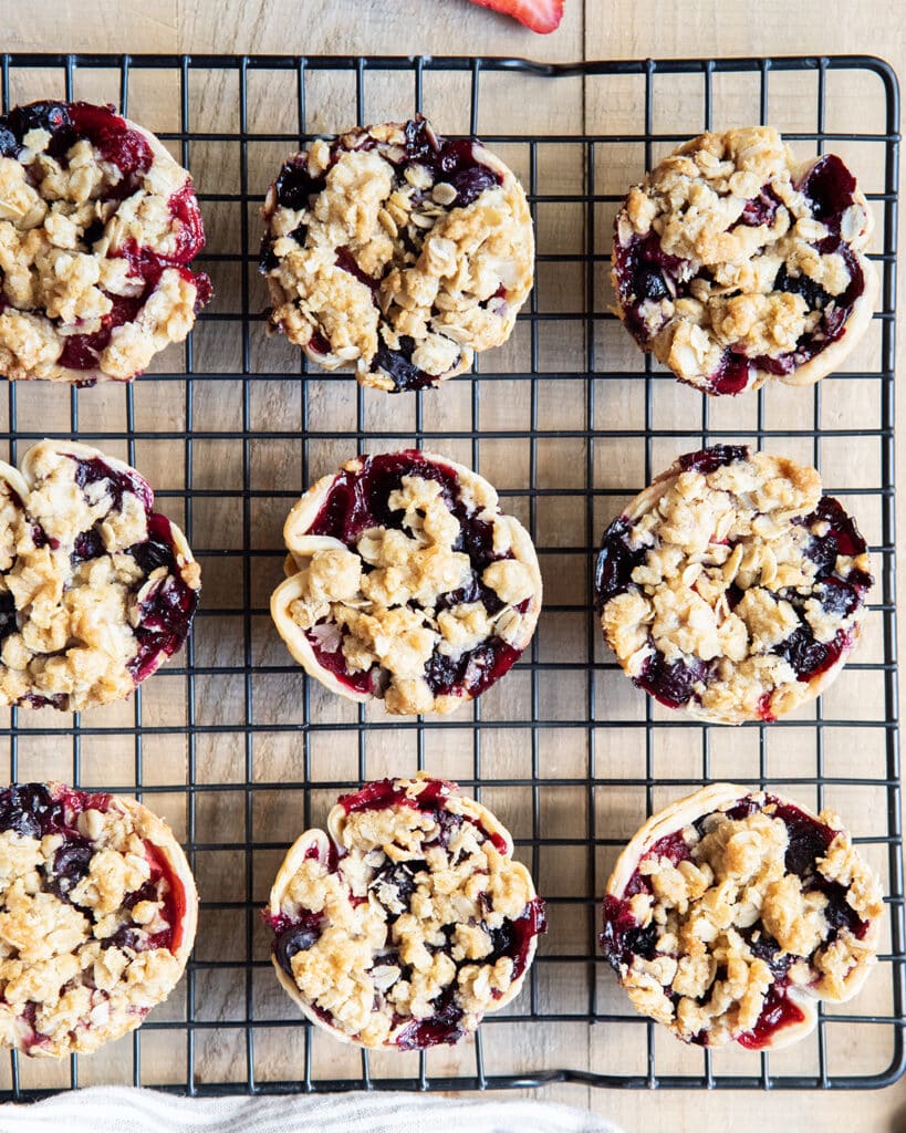 An above view of mini berry toppings on a cooling rack.