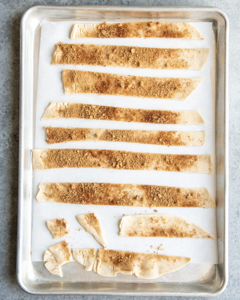 A pan of pie crust strips topped with brown sugar.