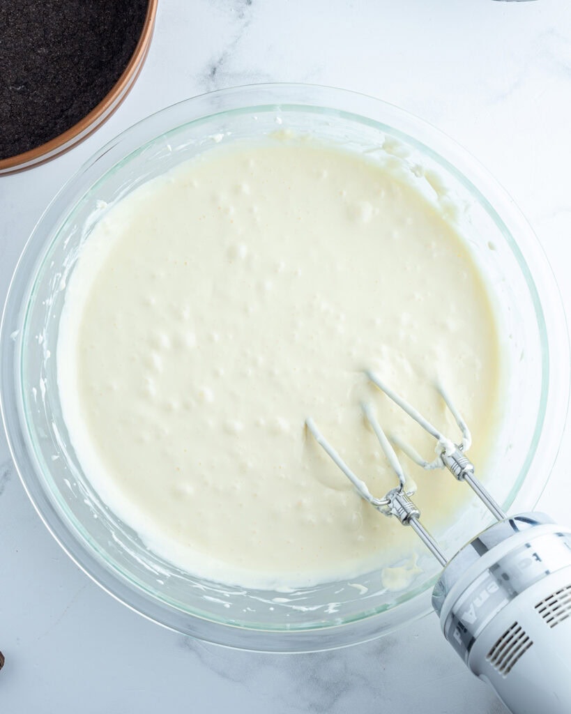 A vanilla cheesecake batter in a bowl.