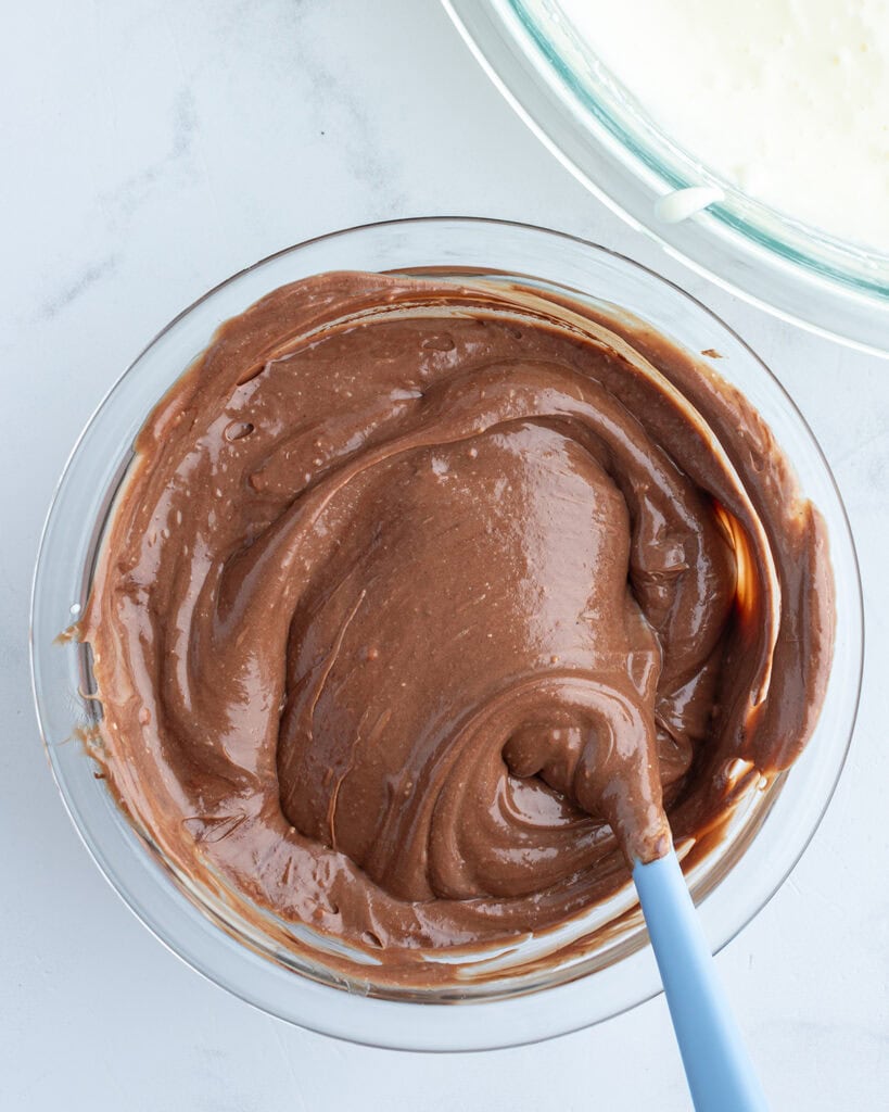 A chocolate cheesecake batter in a bowl.