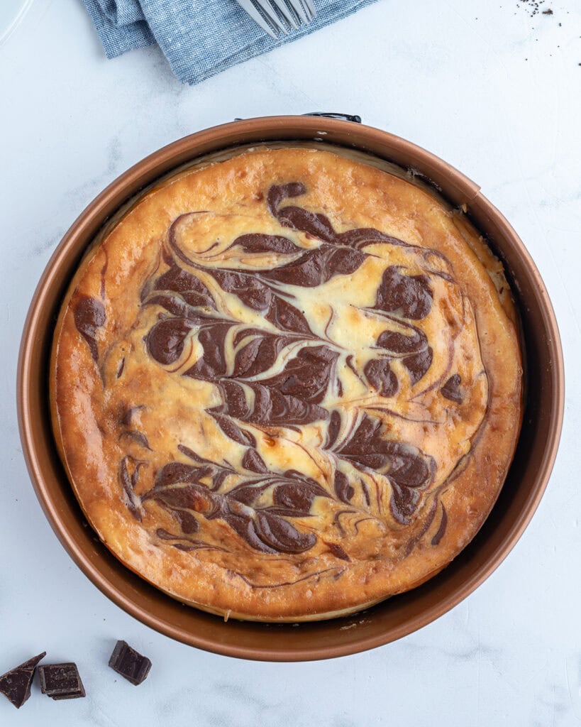 A marbled cheesecake in a spring form pan.