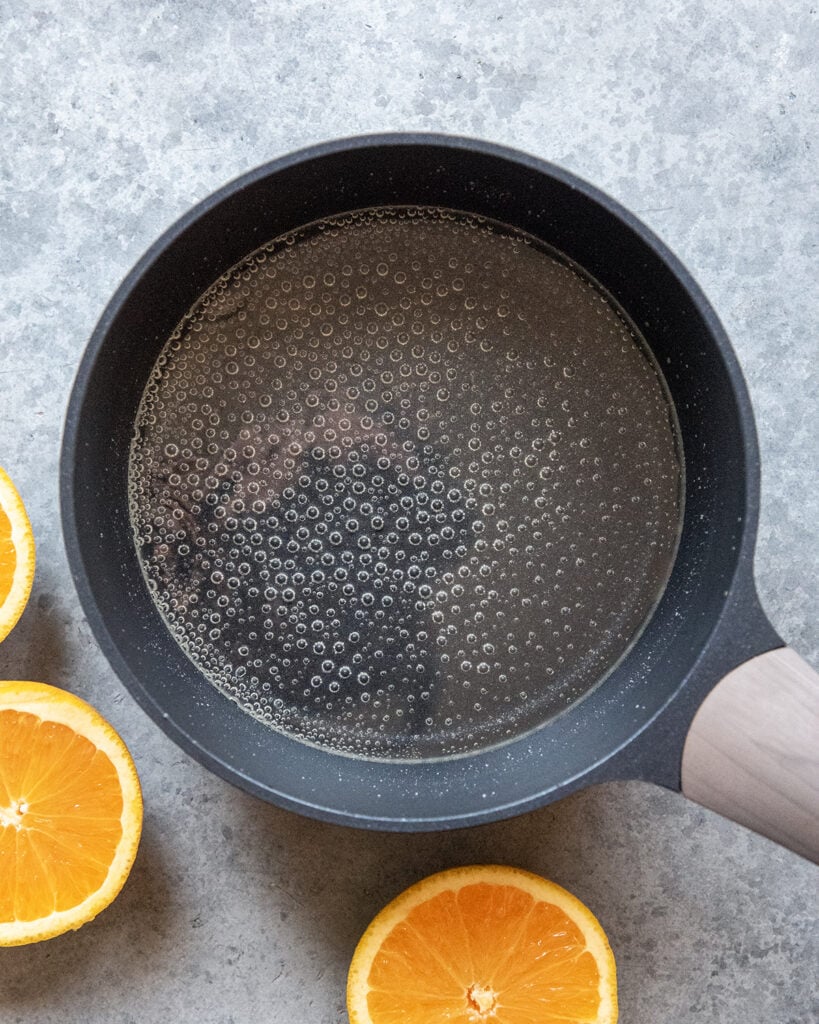 A pot of a clear liquid, simple syrup.