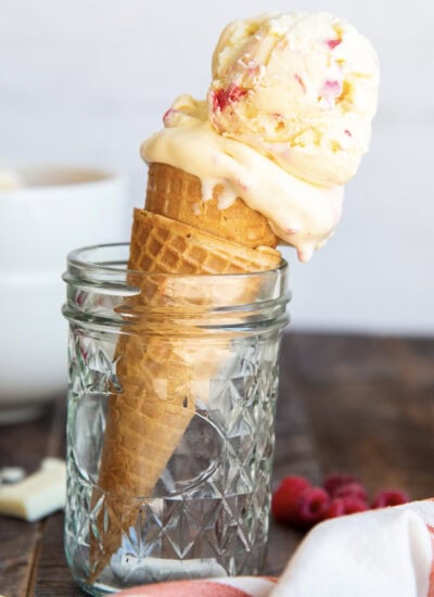 A white chocolate raspberry ice cream cone set in a glass jar.