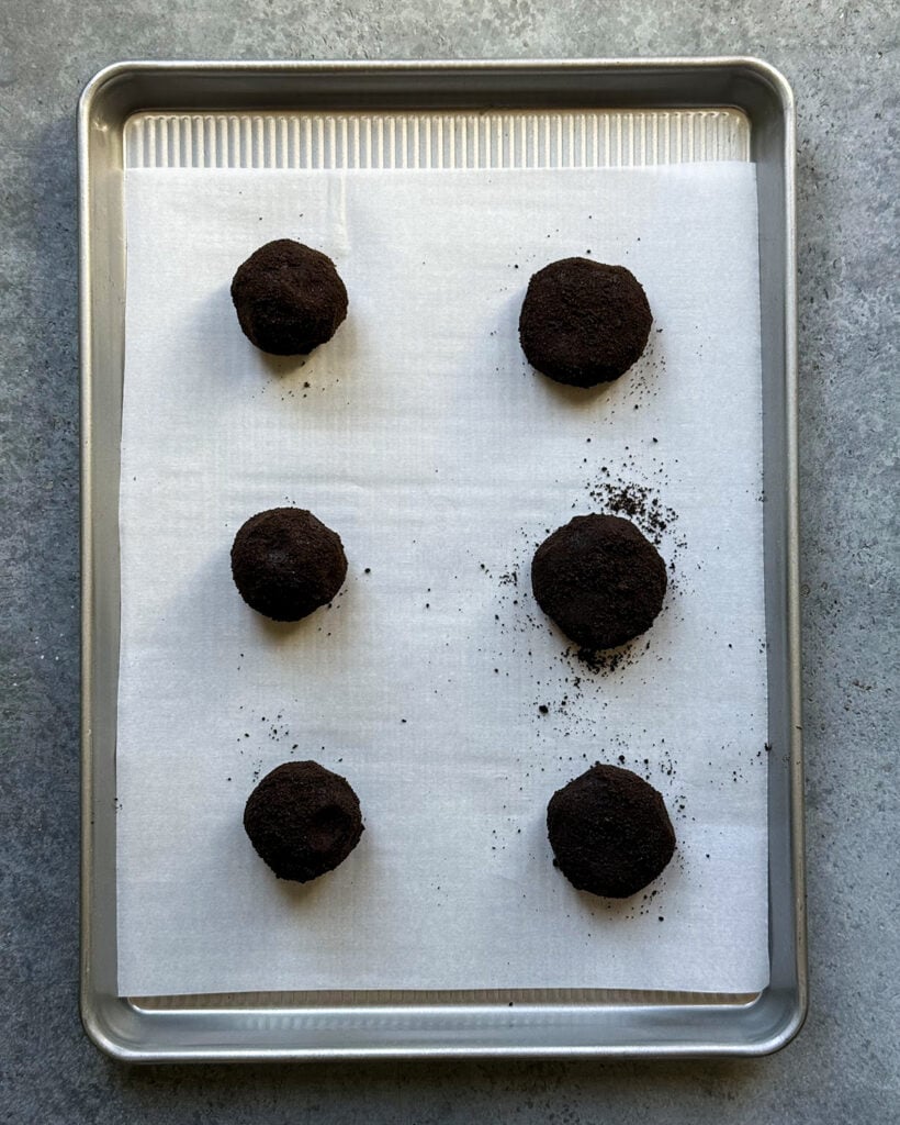 Round cookie dough balls rolled in Oreo crumbs.