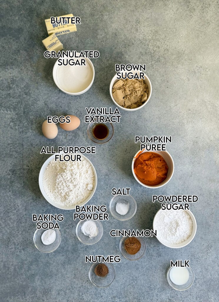 Bowls of the ingredients needed to make pumpkin muffins, including sugar, brown sugar, flour, pumpkin, cinnamon, etc.