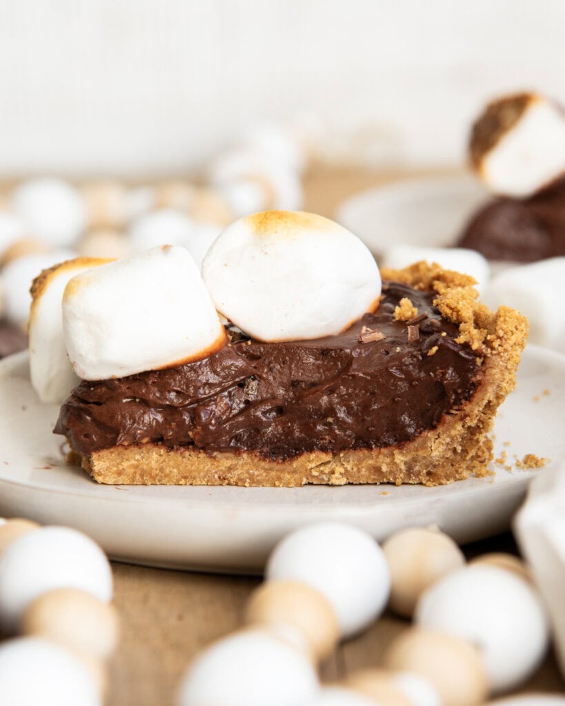 A slice of chocolate pie topped with toasted marshmallows. 