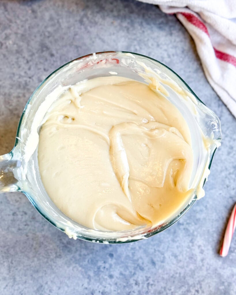 A glass mixing bowl full of white chocolate fudge.