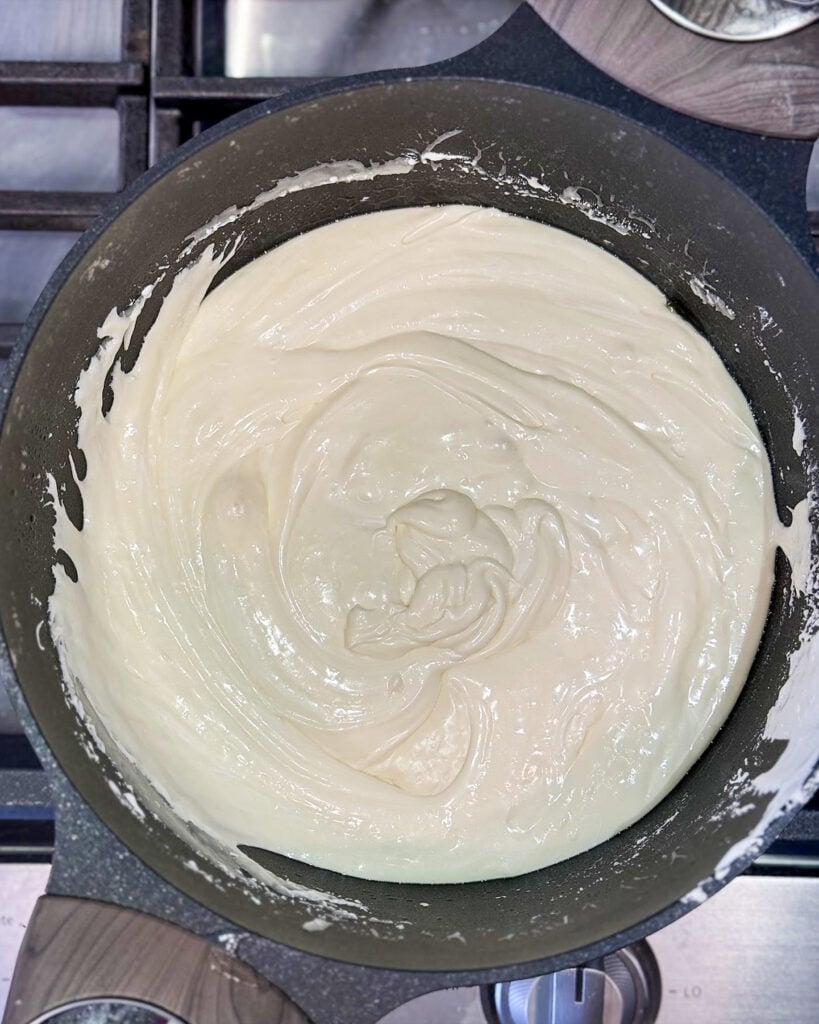 Marshmallow fluff fudge in a black pot.