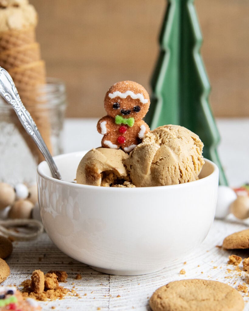 A bowl of gingerbread ice cream topped with a marshmallow gingerbread man.