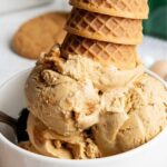 A big bowl full of gingerbread cookie ice cream, topped with upside down ice cream cones.