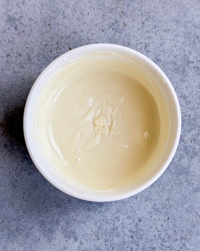 Melted white chocolate in a bowl.