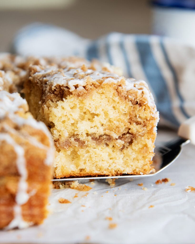 A piece of cinnamon coffee cake on a metal spatula.