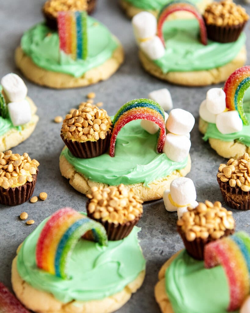 Cookies decorated to look like a rainbow with a pot of gold and with marshmallow clouds