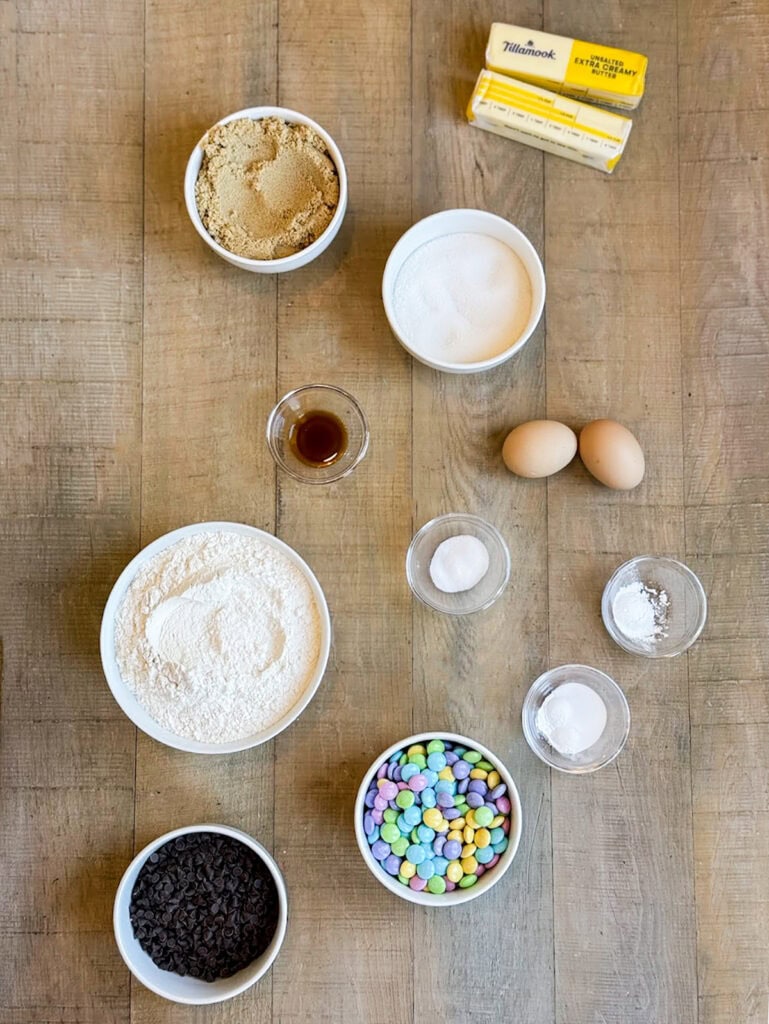 Small bowls of the ingredients needed to make Easter Bunny M&M Cookies.