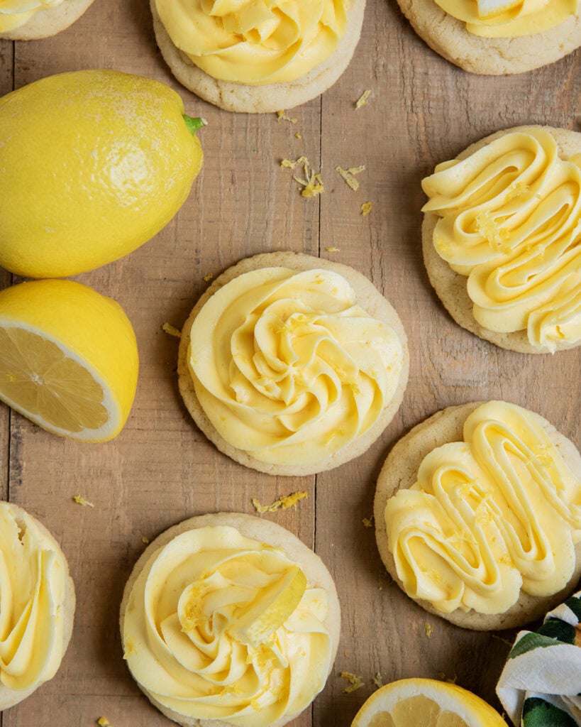 Lemon buttercream piped onto round sugar cookies.