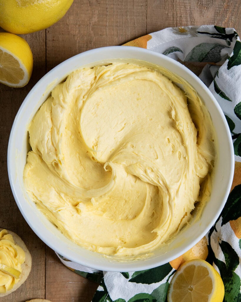 An above view of a bowl of lemon buttercream frosting.