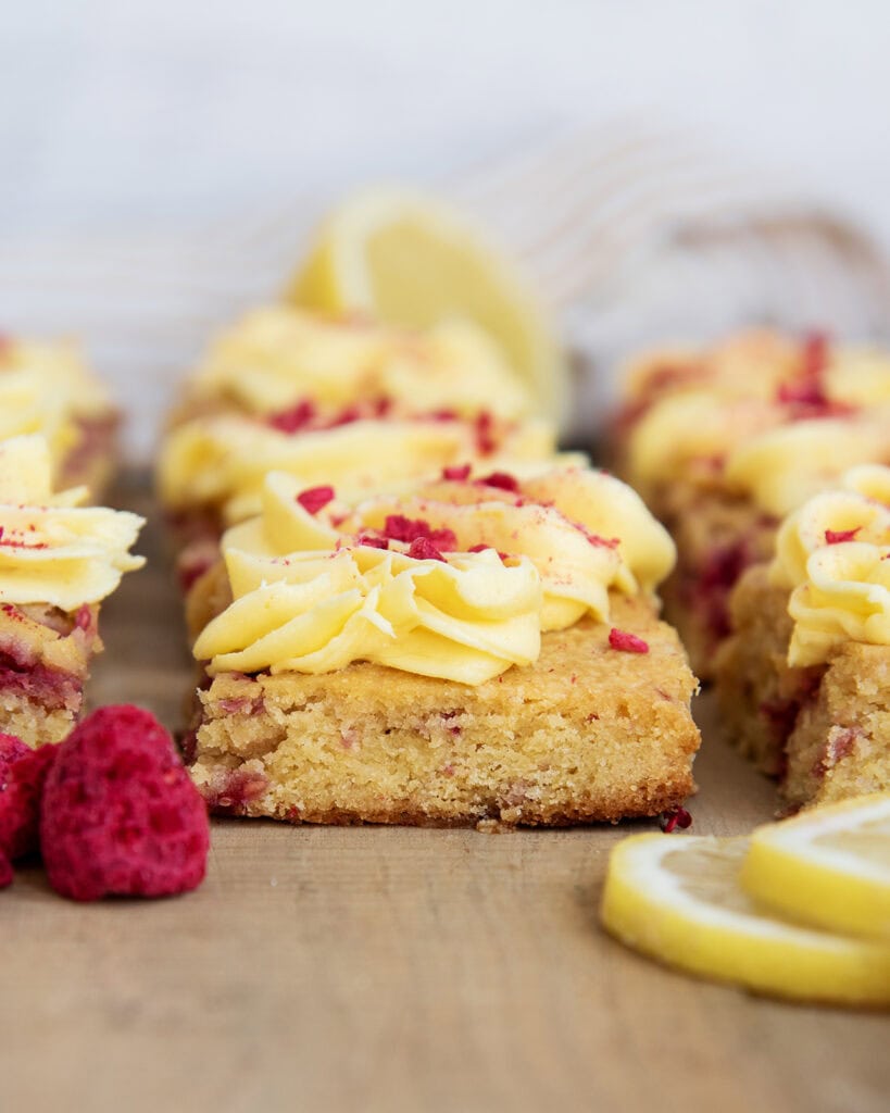 Rows of Raspberry Lemon Blondies with lemon frosting on top.