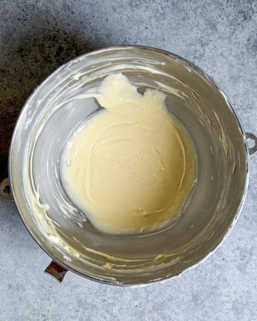Cheesecake filling in a metal bowl.
