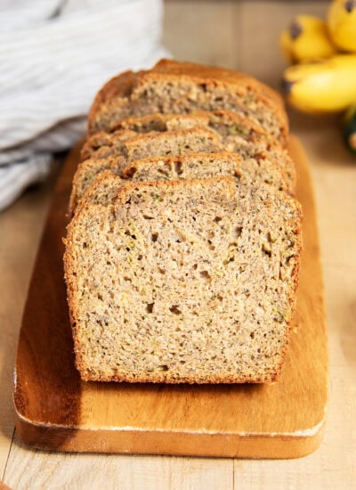 Slices of zucchini bread on a wooden board.
