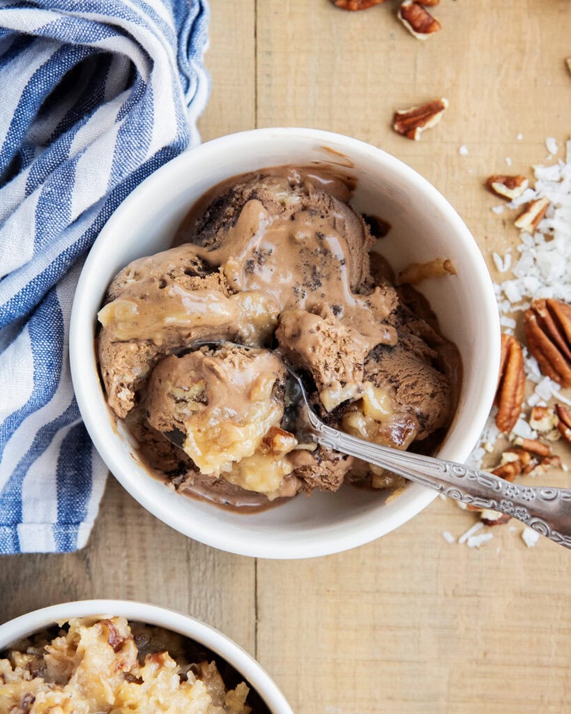 A bowl of German Chocolate Cake Ice cream with a spoon in the bowl.