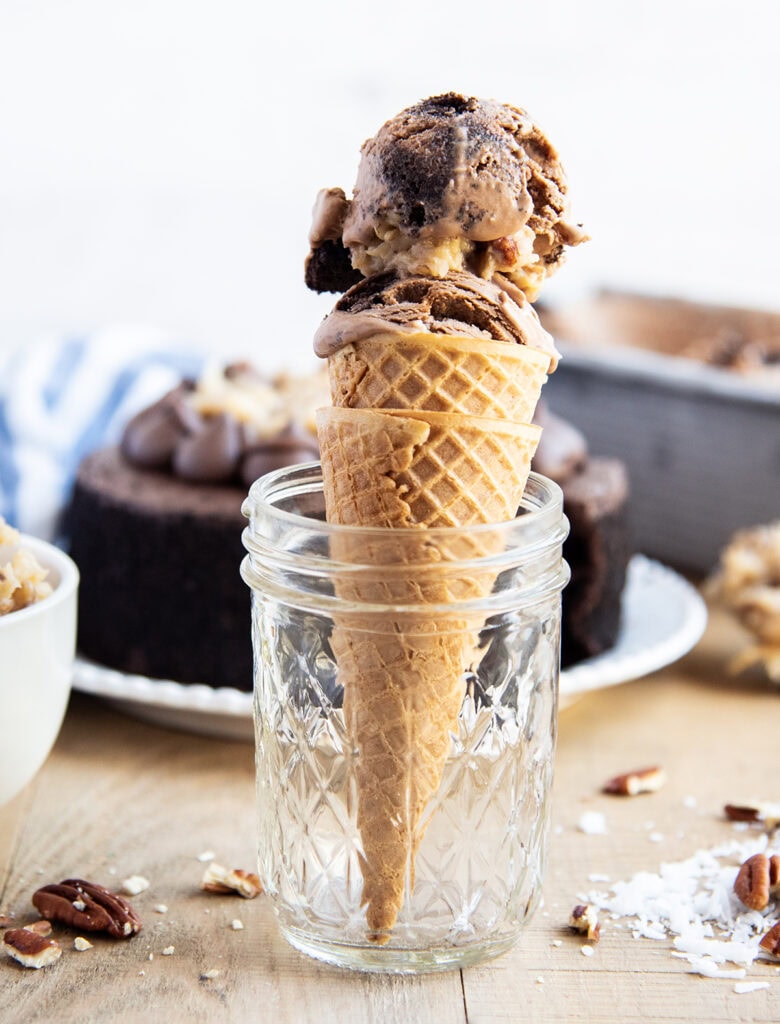An ice cream cone topped with German Chocolate Cake Ice Cream