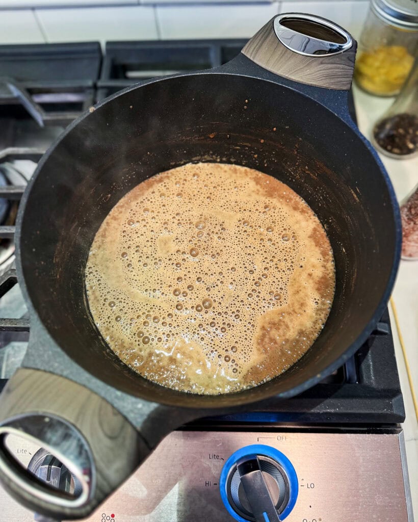 A bowl of a chocolate liquid to make custard for ice cream.