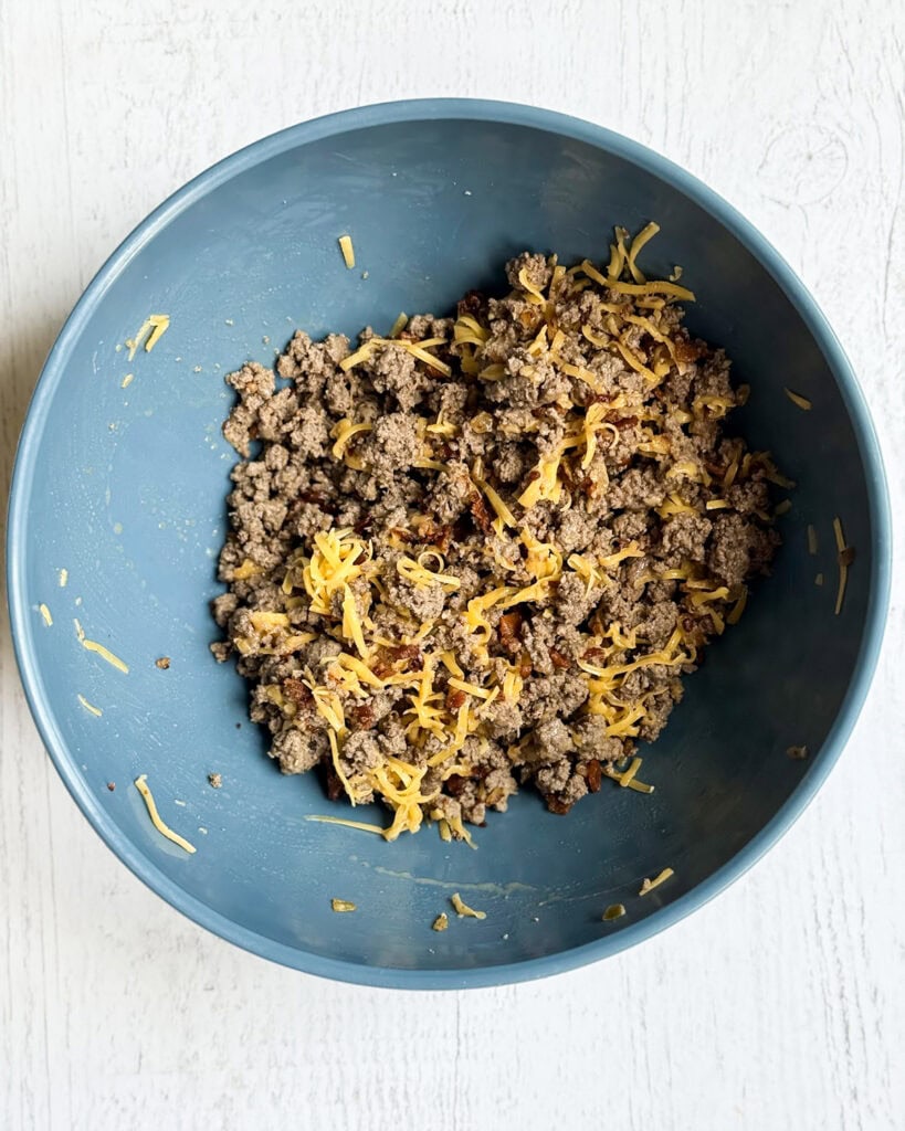 A bowl of ground beef, bacon, and cheese.