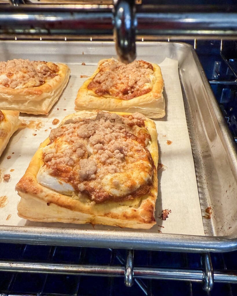 Pumpkin cream cheese danishes baked on a cookie sheet.