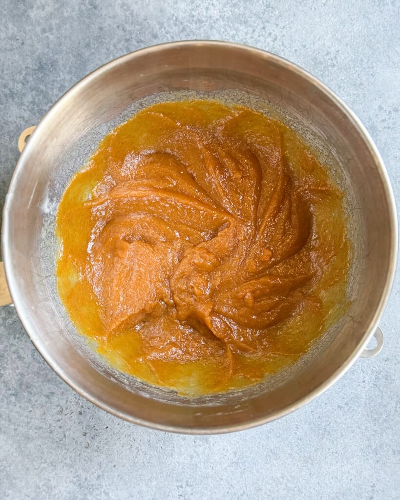 A bowl of creamed butter, and pumpkin that is pumpkin color.